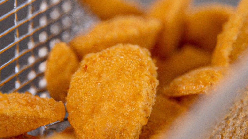 Imagem de couve-flor crocante cozida na airfryer, disposta em uma tigela branca. Os floretes de couve-flor são dourados e crocantes, com algumas bordas levemente queimadas. A couve-flor é polvilhada com sal e pimenta e decorada com uma pitada de salsa fresca.