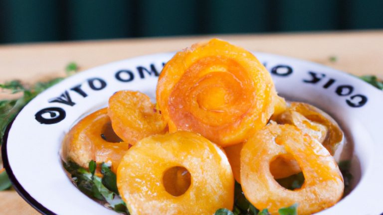 Imagem de cubinhos de batata-doce crocantes e dourados cozidos em uma Airfryer. Essas batatas fritas caseiras são feitas com batatas-doces frescas cortadas em cubos, revestidas com azeite e temperadas com sal e pimenta. Elas são cozidas na Airfryer por 25 minutos, resultando em um lanche ou acompanhamento crocante e delicioso.