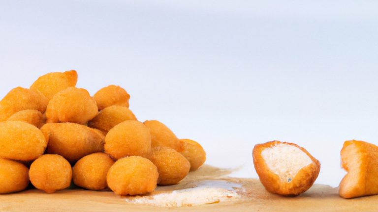 Imagem de uma airfryer aberta com uma cesta cheia de farinha panko dourada e crocante. A farinha panko é uma migalha de pão japonesa feita de pão sem casca e é usada para empanar alimentos para dar-lhes uma textura crocante.