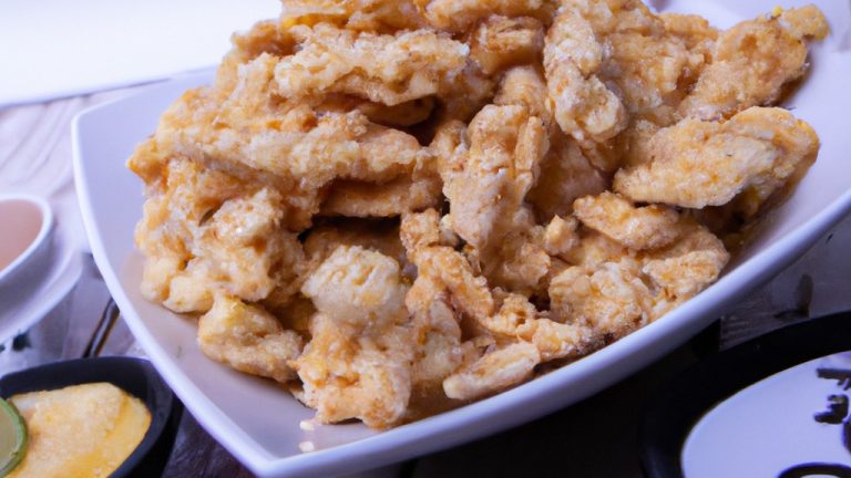 Frango empanado crocante e dourado na Airfryer, coberto com uma crosta crocante de corn flakes. O frango é suculento e macio por dentro, enquanto o empanamento é crocante e saboroso.