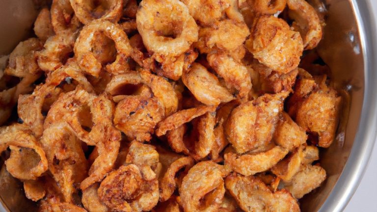 Imagem de uma tigela cheia de grãos crocantes cozidos na Airfryer. Os grãos são dourados e crocantes, com uma textura leve e arejada. Eles são perfeitos para um lanche saudável ou como acompanhamento de uma refeição.