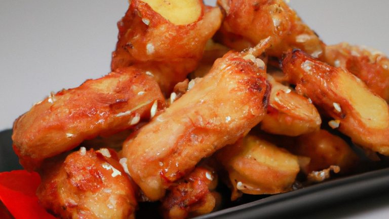 Imagem de um prato com kani empanado e frito na airfryer, acompanhado de molho tarê. O kani está dourado e crocante, com uma aparência deliciosa.