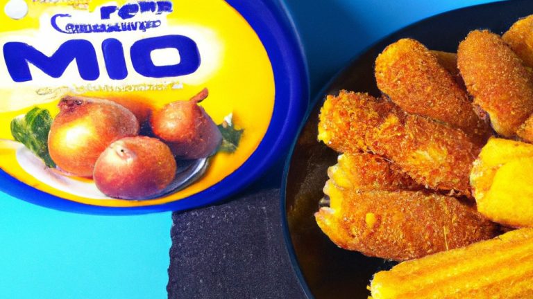 Imagem de milho cozido em uma airfryer. O milho é dourado e ligeiramente carbonizado, e está disposto em uma tigela com um pouco de sal e pimenta.