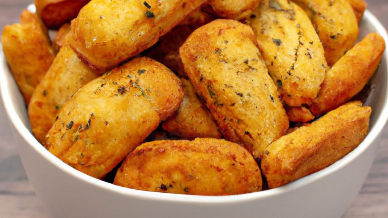 Imagem de uma air fryer com uma porção de moela crocante cozida dentro. A moela está dourada e tem uma aparência crocante e saborosa.