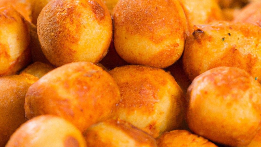 Imagem de uma cesta de Panados Airfryer de 10 polegadas cheia de panados dourados e crocantes. Os panados são servidos em um prato branco com um lado de molho para mergulhar.