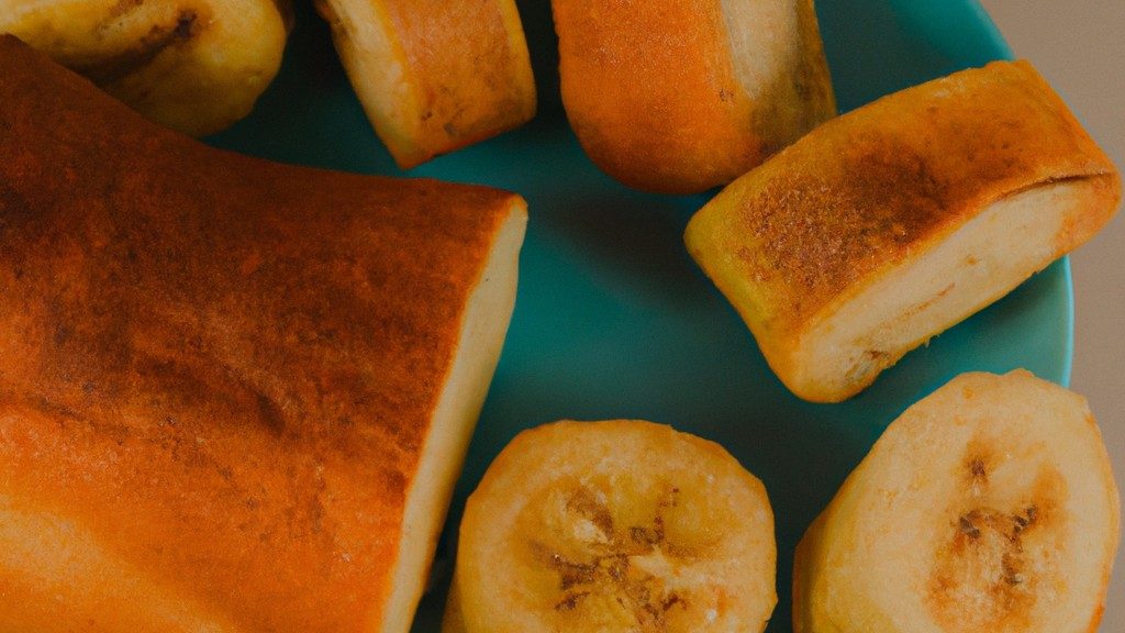 Imagem de pão de banana e canela cozido em uma airfryer. O pão tem uma crosta marrom-dourada e é polvilhado com canela. O pão é cortado ao meio e cozido em uma cesta de airfryer.