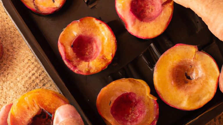 Uma fotografia de pêssegos assados na airfryer. Os pêssegos são cortados ao meio, sem caroço e assados até ficarem macios e caramelizados. Eles são polvilhados com canela e servidos com uma colher de sorvete de baunilha.