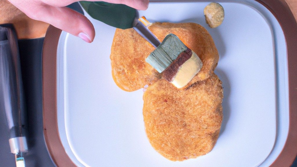 Imagem de uma porção de provolone à milanesa frita em uma fritadeira Airfryer. O queijo está empanado com farinha de rosca e assado até ficar dourado e crocante.