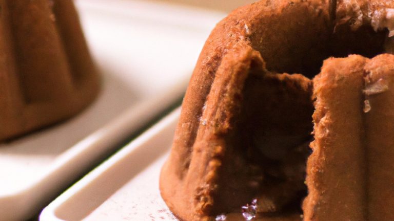 Imagem de um delicioso pudim de chocolate cozido em uma airfryer, com uma textura cremosa e uma crosta crocante. O pudim é servido em um prato branco com uma colher ao lado.