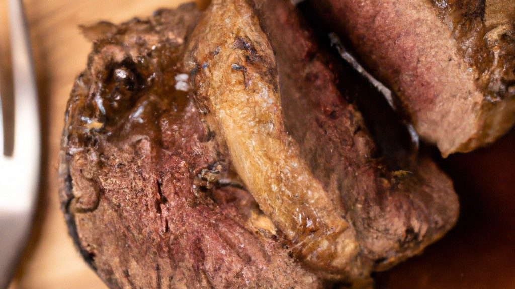 Imagem de medalhões de carne moída cozidos na Airfryer, servidos em um prato com arroz e legumes. Os medalhões são dourados e crocantes, com um interior suculento.