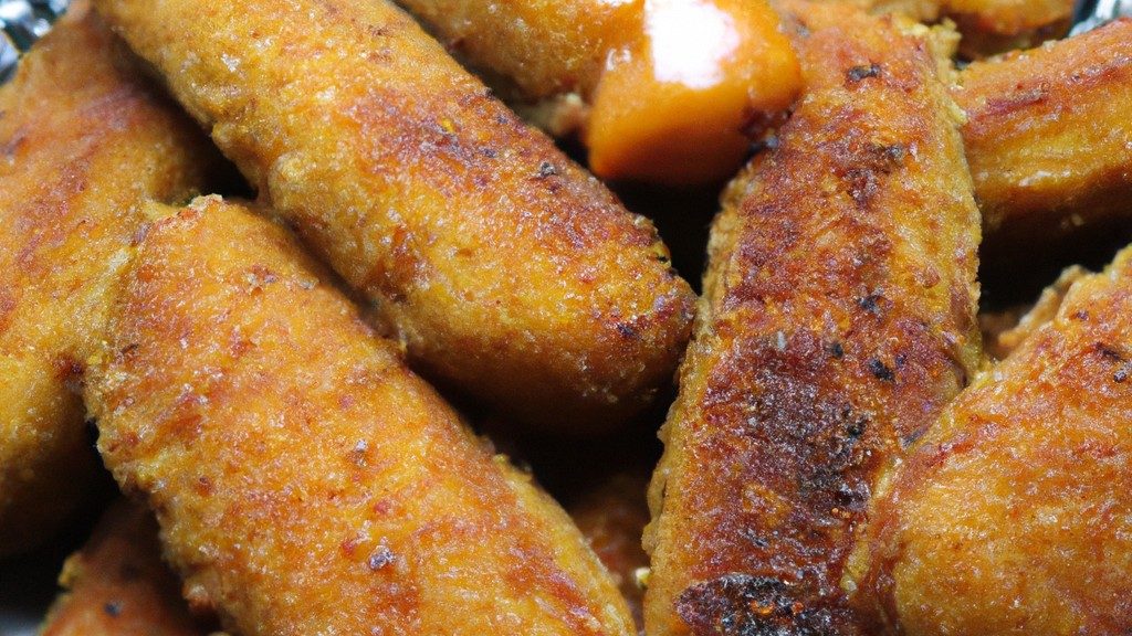 Imagem de um robalo inteiro assado na Airfryer, com pele crocante e dourado, servido em um prato branco com rodelas de limão ao lado.