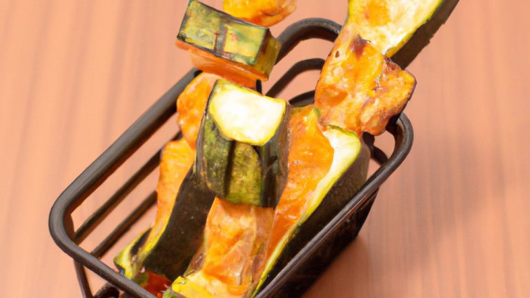 Imagem de palitos de abobrinha crocantes e dourados preparados na airfryer, servidos com um molho de sua preferência. Esses palitos são uma opção de aperitivo ou lanche saudável e deliciosa, perfeitos para dias quentes de verão.
