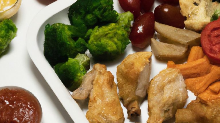 Imagem de sobrecoxas de frango douradas e suculentas em uma cesta de airfryer, cercadas por vegetais coloridos como brócolis, cenoura e batata. A imagem mostra uma refeição saudável e saborosa preparada com facilidade usando uma airfryer.