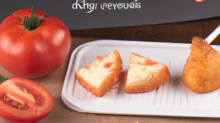 Imagem de tomates cortados ao meio e recheados com queijo branco, assados em uma airfryer. Os tomates estão dourados e o queijo está derretido e borbulhante.