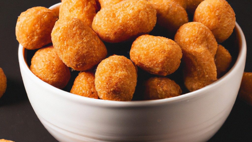 Imagem de uma fritadeira de ar de alta capacidade da Oster, com acabamento em aço inoxidável. A fritadeira tem um cesto grande e quadrado, com uma alça preta. O painel de controle digital fica na parte superior da fritadeira, com botões para ajustar a temperatura e o tempo.