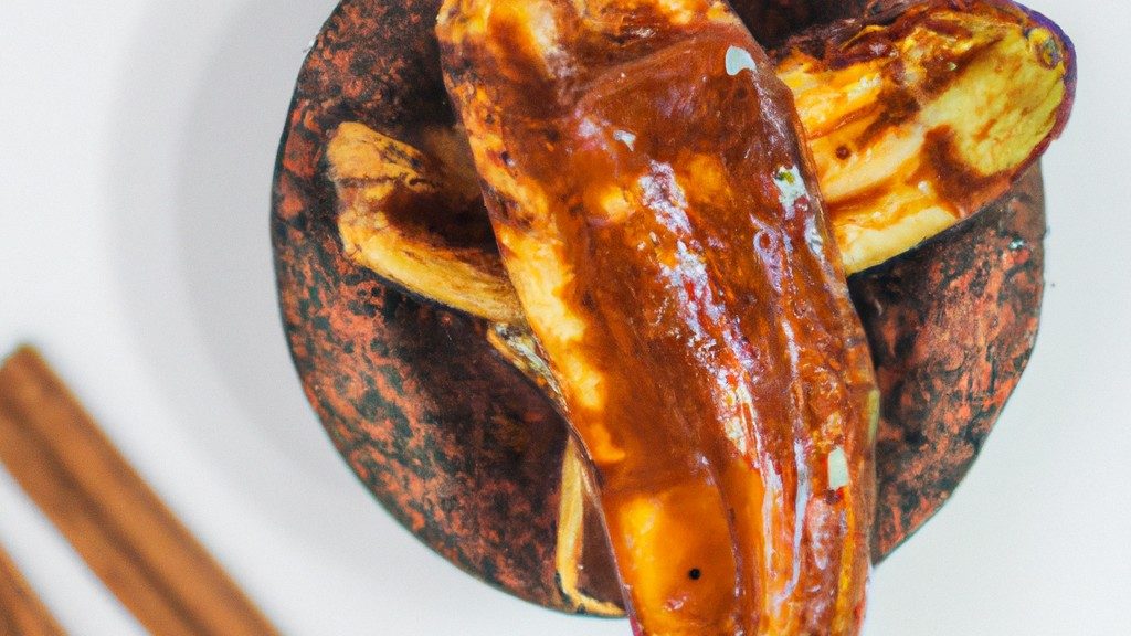 Imagem de uma banana caramelizada crocante cozida em uma Air Fryer, com um exterior dourado e um interior macio e caramelizado.