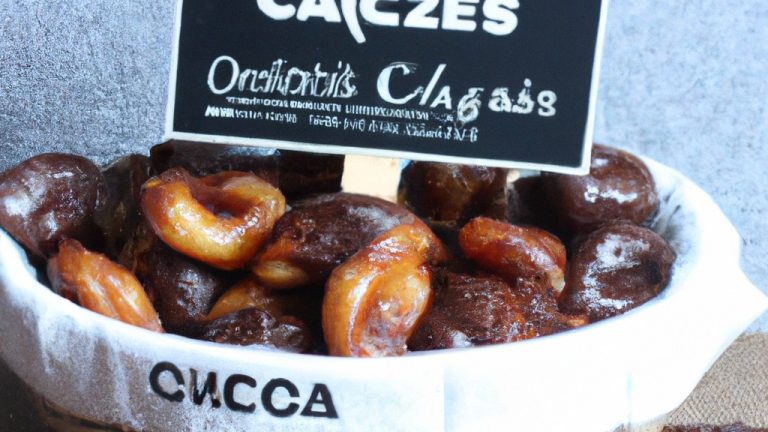 Imagem de castanhas doces cozidas em uma Air Fryer, polvilhadas com açúcar e canela. As castanhas são de cor marrom escura com uma superfície brilhante e crocante. O açúcar e a canela polvilhados por cima adicionam um toque doce e picante às castanhas.