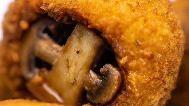 Uma fotografia de cogumelos brancos recheados com uma mistura cremosa e crocante, preparados em uma Airfryer. Os cogumelos são dourados e perfeitamente cozidos, com a mistura de recheio derretida e borbulhando por cima. A foto mostra o prato pronto para ser servido, com uma guarnição de salsa fresca e um toque de azeite.