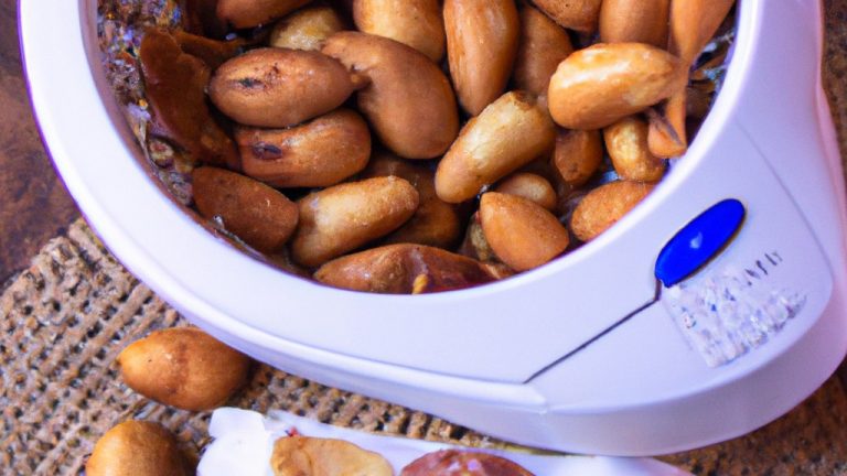 Imagem de uma airfryer com amendoins torrados dentro dela. Os amendoins são dourados e crocantes, e estão prontos para serem consumidos.