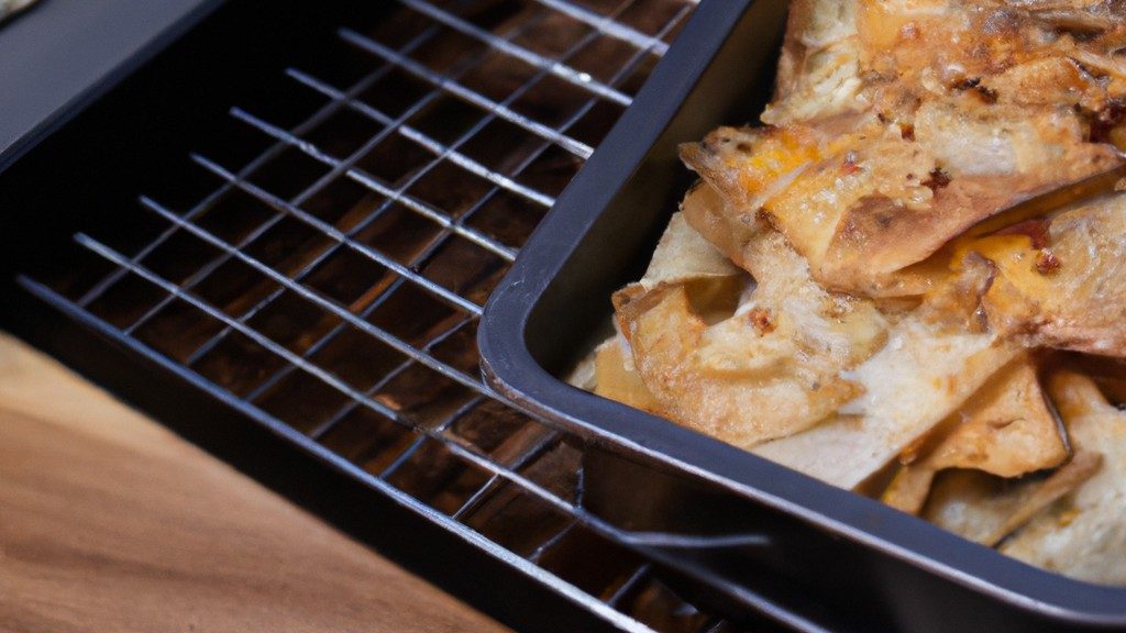 Imagem de Crumble de Maçã quente e borbulhante em uma Airfryer. A cobertura dourada e crocante contrasta lindamente com o recheio de maçã suculento e especiado. A Airfryer é visível ao fundo, proporcionando uma maneira saudável e conveniente de preparar este clássico da sobremesa.