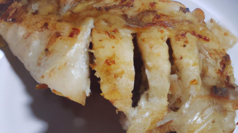 Imagem de filé de peixe grelhado frito na airfryer, servido com limão e ervas frescas. O peixe é dourado e crocante por fora, e branco e escamoso por dentro.