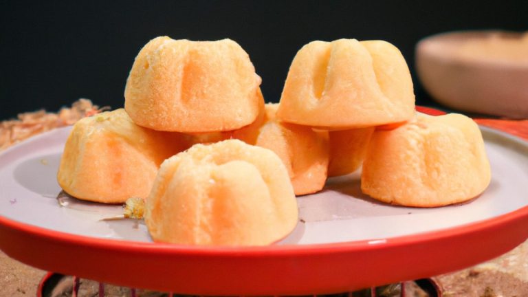 Imagem de um grand gâteau feito em airfryer. O bolo é dourado e tem uma camada crocante por cima. O interior é macio e fofo, com uma textura semelhante a um soufflé. A imagem mostra o bolo cortado em fatias, revelando seu interior leve e arejado.