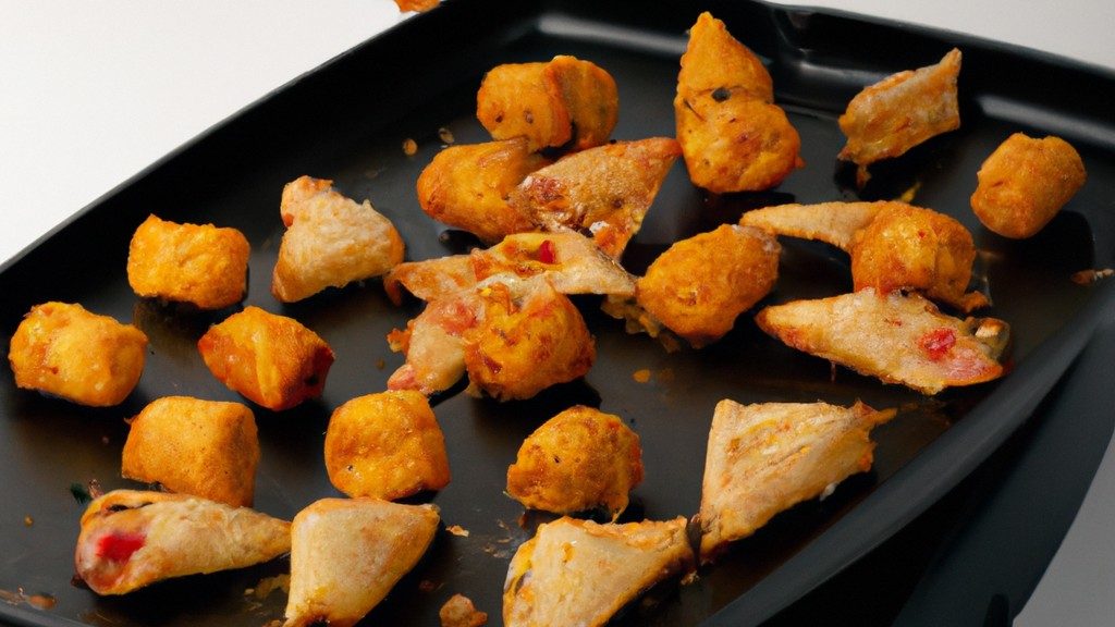 Imagem de uma Airfryer Qibe com vários sabores diferentes de qibe, incluindo carne, frango e vegetais. A fritadeira é mostrada de frente, com a cesta aberta e o qibe cozido dentro. O fundo é branco e a imagem é bem iluminada.