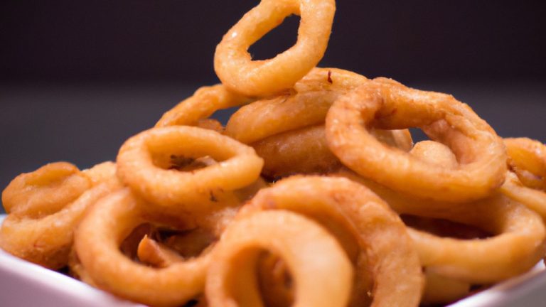 Anéis de cebola dourados e crocantes, preparados na Airfryer para uma opção mais saudável e deliciosa.