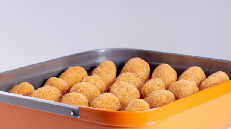 Imagem de um quibe frito e dourado em uma airfryer. O quibe é feito com carne moída, trigo bulgur e especiarias. Ele é moldado em uma forma oval e frito até ficar crocante.