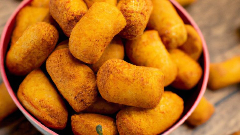 Imagem de uma Airfryer com uma cesta cheia de comida cozida, como batatas fritas, nuggets de frango e vegetais. O texto "Airfryer Receita Deliciosa" está escrito no canto inferior direito.